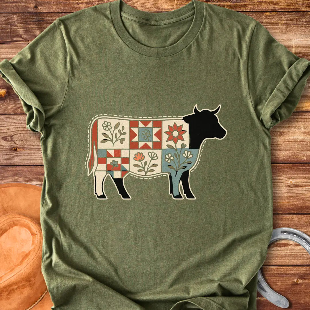 Quilt Blooms T-Shirt featuring a cow silhouette with a patchwork quilt pattern and floral details.