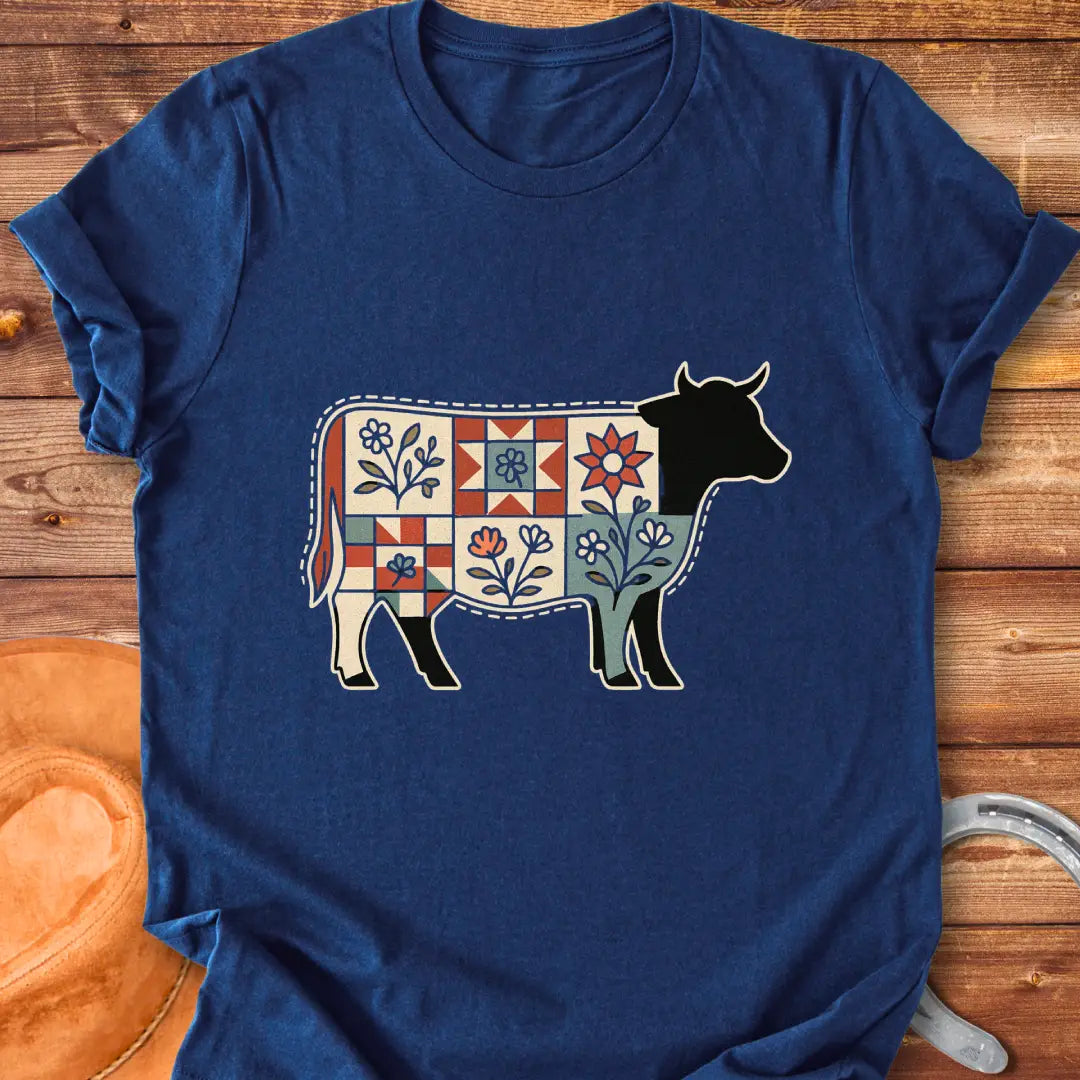 Quilt Blooms T-Shirt featuring a cow silhouette with a patchwork quilt pattern and floral details.