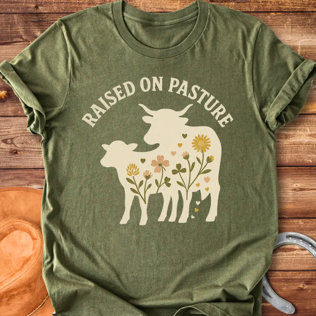 Raised On Pasture T-Shirt featuring a cow silhouette filled with flowers and hearts.