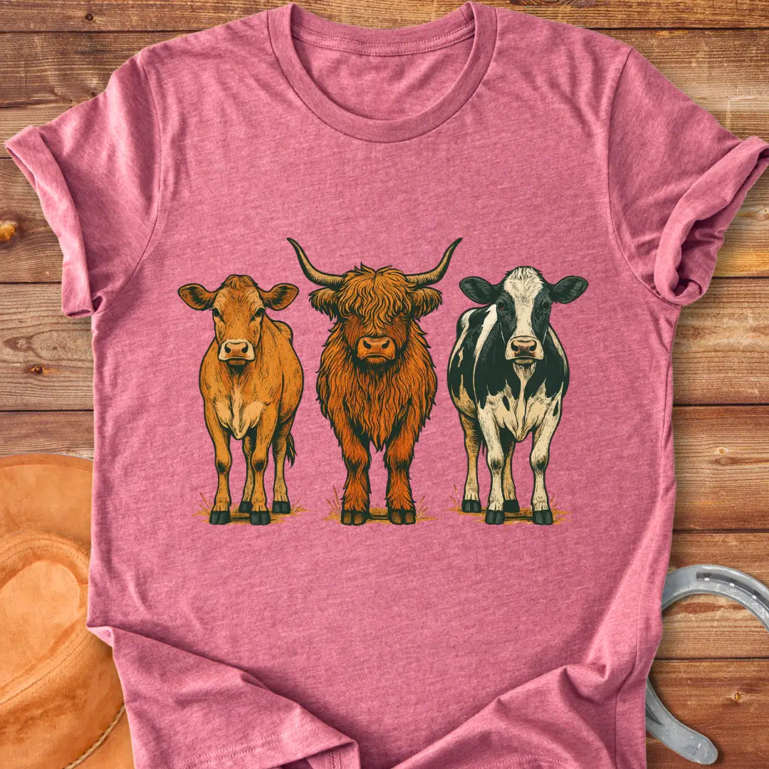 Rustic art t-shirt featuring three different cow breeds: a brown cow, a Highland cow, and a black and white cow.