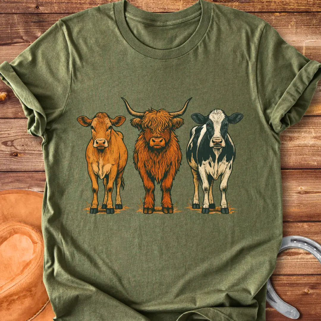 Rustic art t-shirt featuring three different cow breeds: a brown cow, a Highland cow, and a black and white cow.
