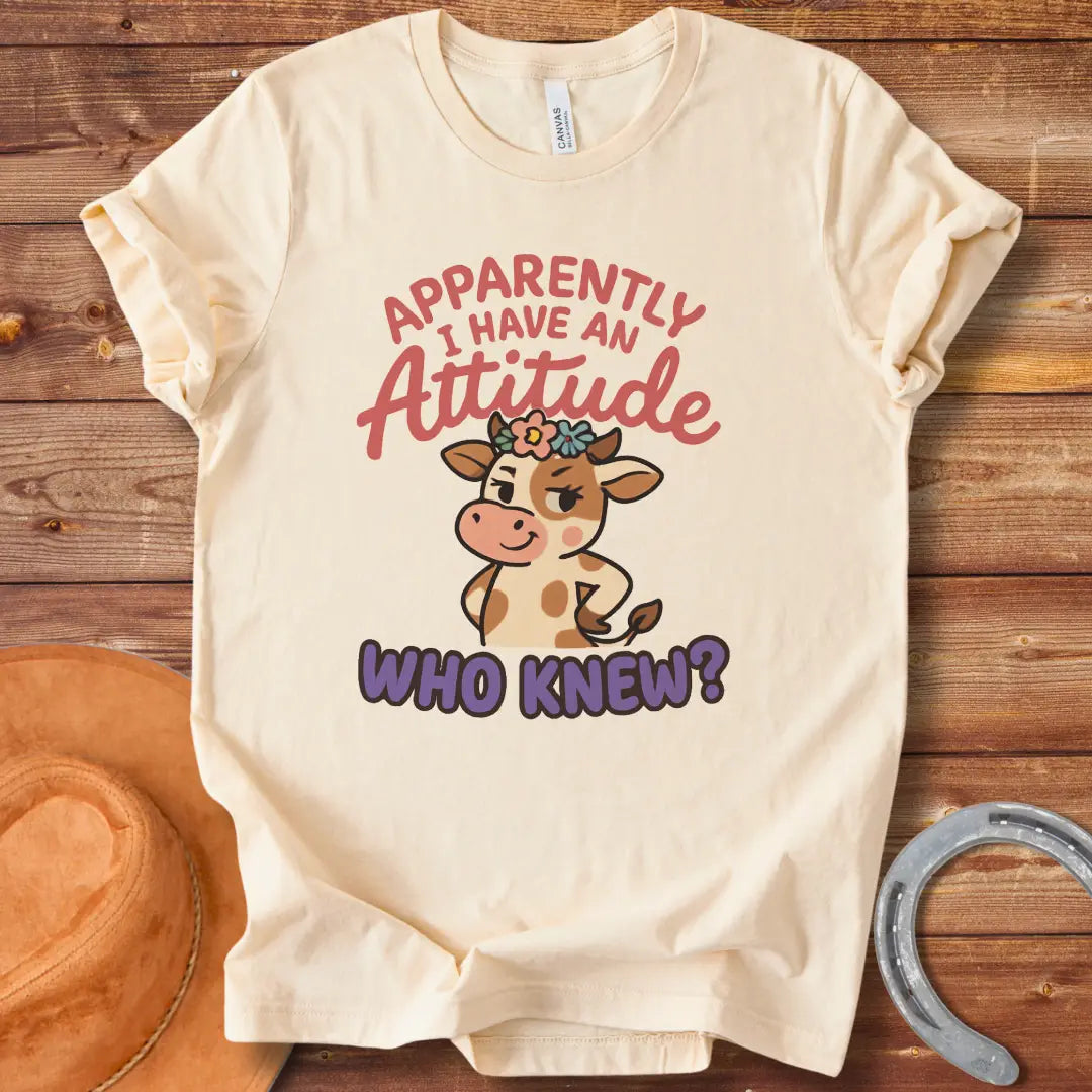 Illustration of a sassy cow wearing a floral crown and winking, with the words 'Apparently I Have An Attitude. Who Knew?'