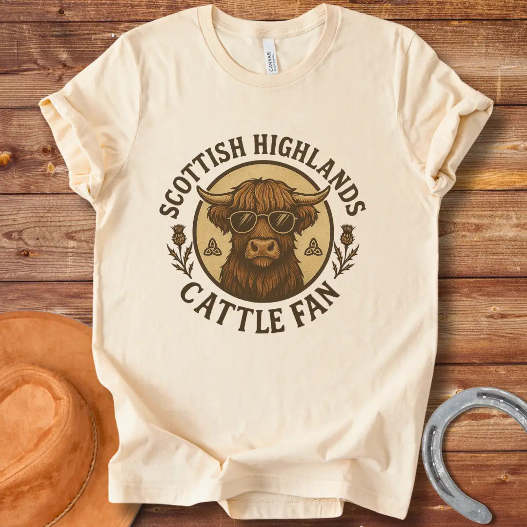 Scottish Highland cow wearing sunglasses, surrounded by text and thistle artwork