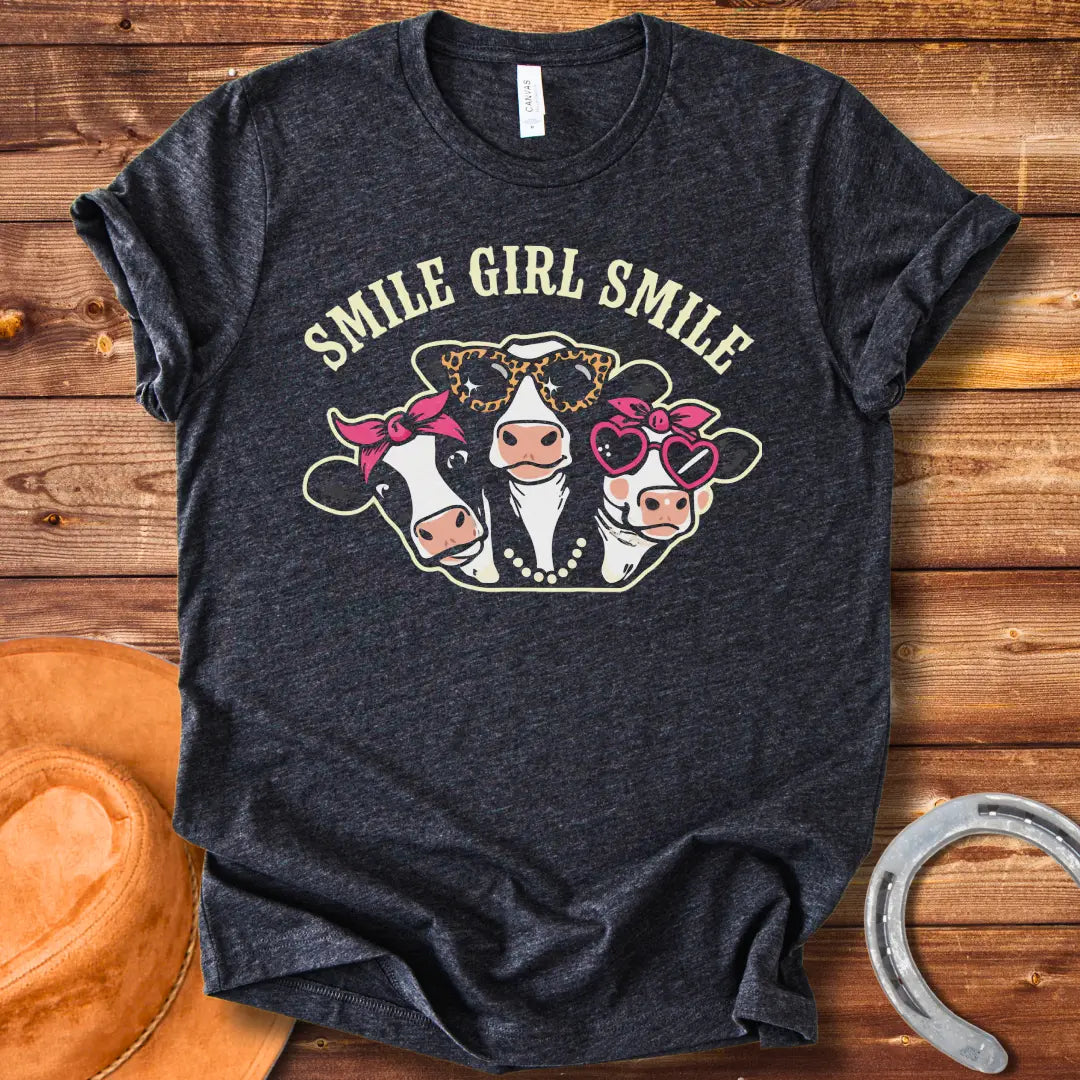 T-shirt featuring three smiling cows wearing sunglasses, bandanas, and pearls with the text 'Smile Girl Smile'