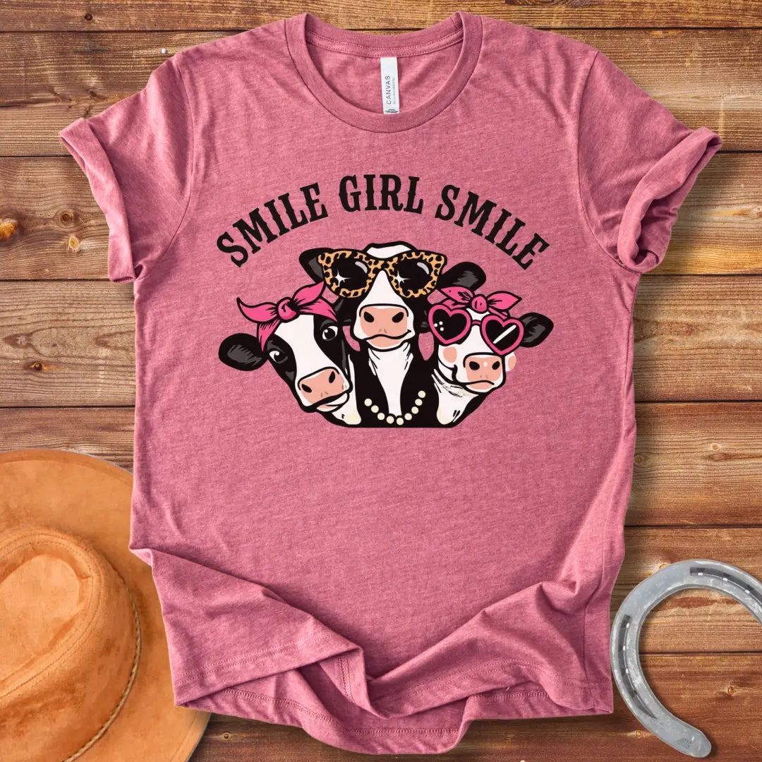 T-shirt featuring three smiling cows wearing sunglasses, bandanas, and pearls with the text 'Smile Girl Smile'