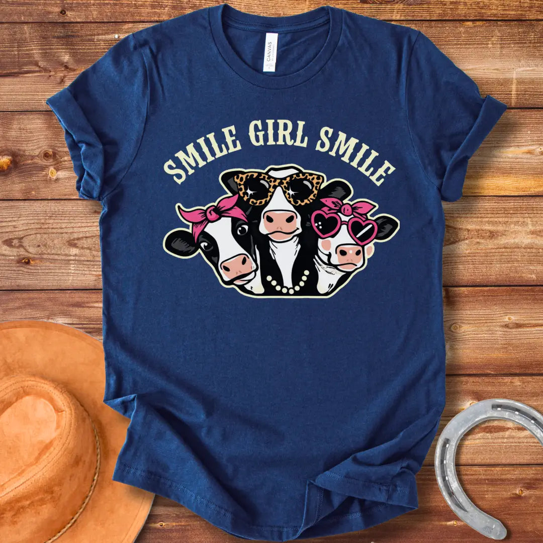 T-shirt featuring three smiling cows wearing sunglasses, bandanas, and pearls with the text 'Smile Girl Smile'