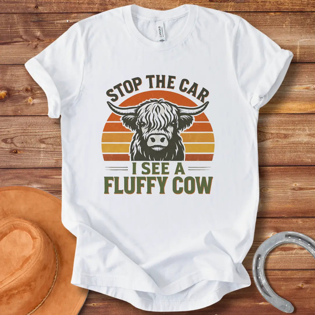 Vintage-style t-shirt design with a fluffy cow, the text 'Stop the Car, I see a Fluffy Cow' in a retro design.