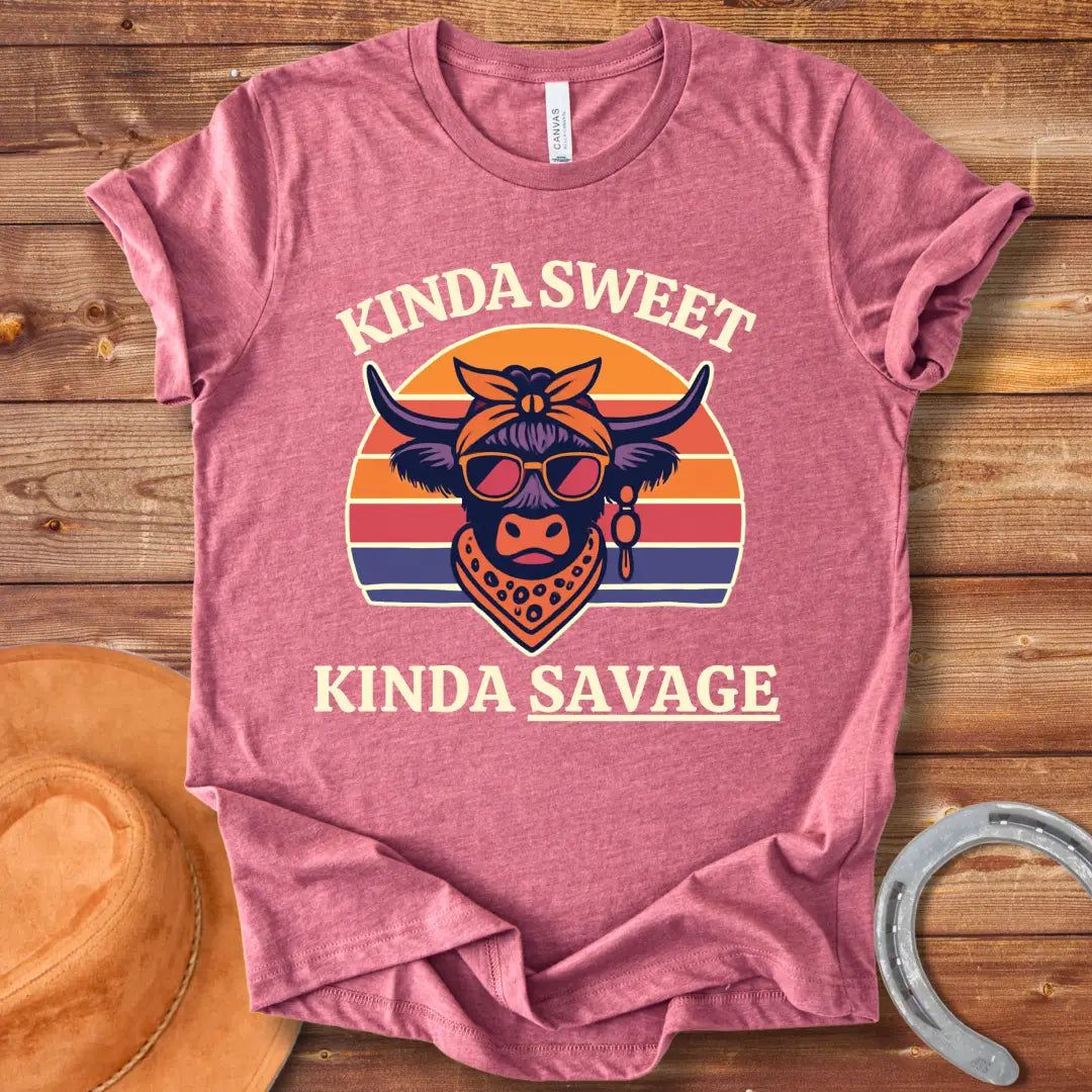 Retro t-shirt with a cool cow graphic, sunglasses, bandana, and the words 'Kinda Sweet, Kinda Savage' in a sunset background.