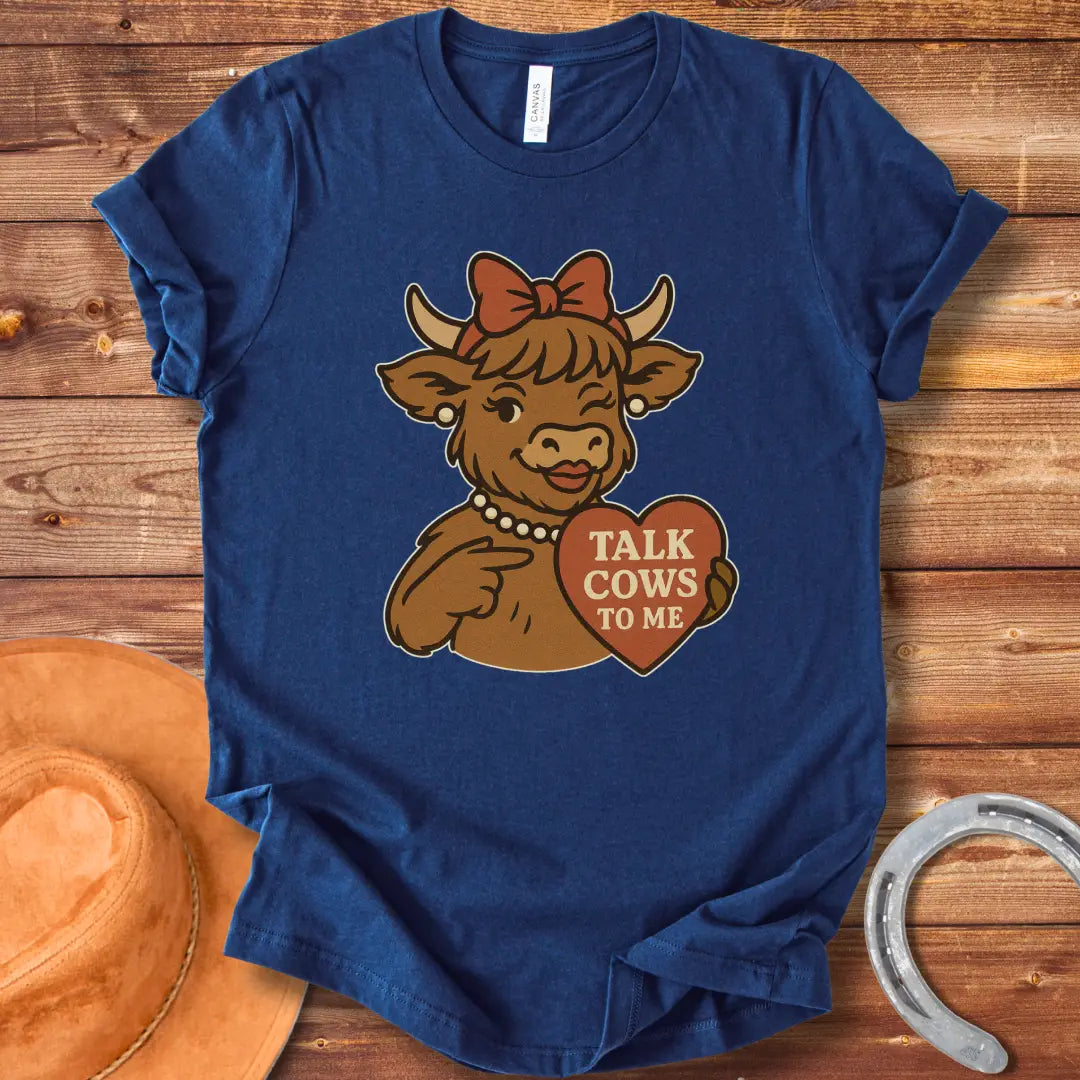 Charming cow wearing a bow and pearl necklace, holding a heart-shaped sign that says 'Talk Cows To Me'