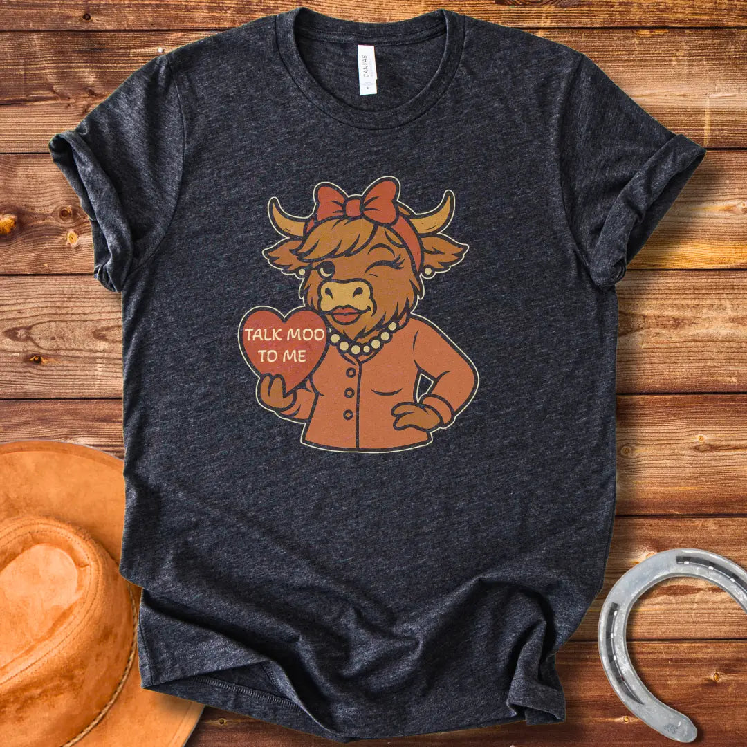 Talk Moo To Me T-Shirt design featuring a stylish winking cow holding a heart
