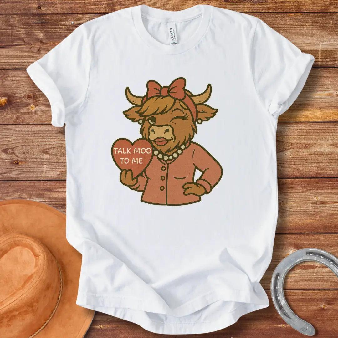 Talk Moo To Me T-Shirt design featuring a stylish winking cow holding a heart