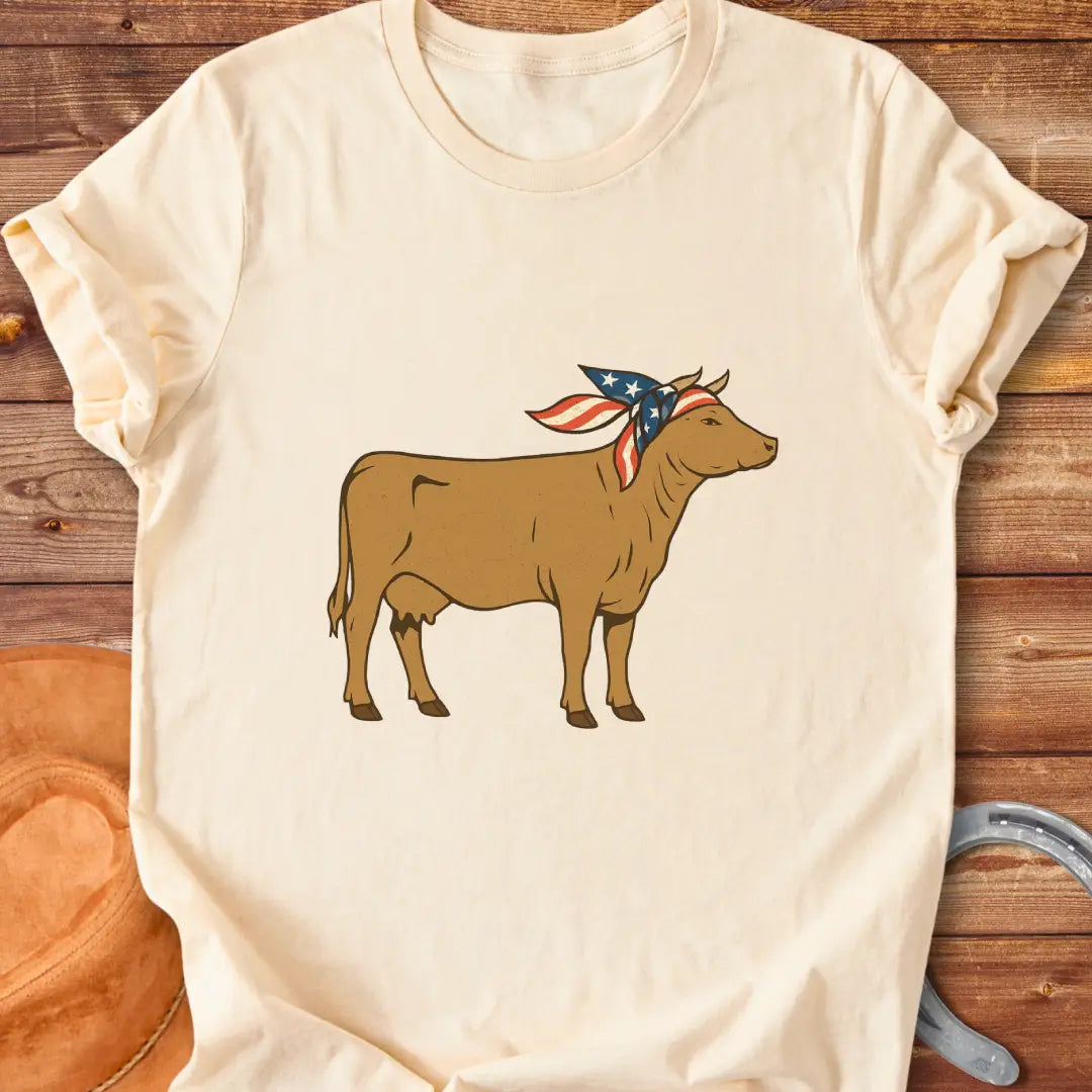 USA Cowgirl T-Shirt featuring a brown cow wearing an American flag bandana, patriotic cow design