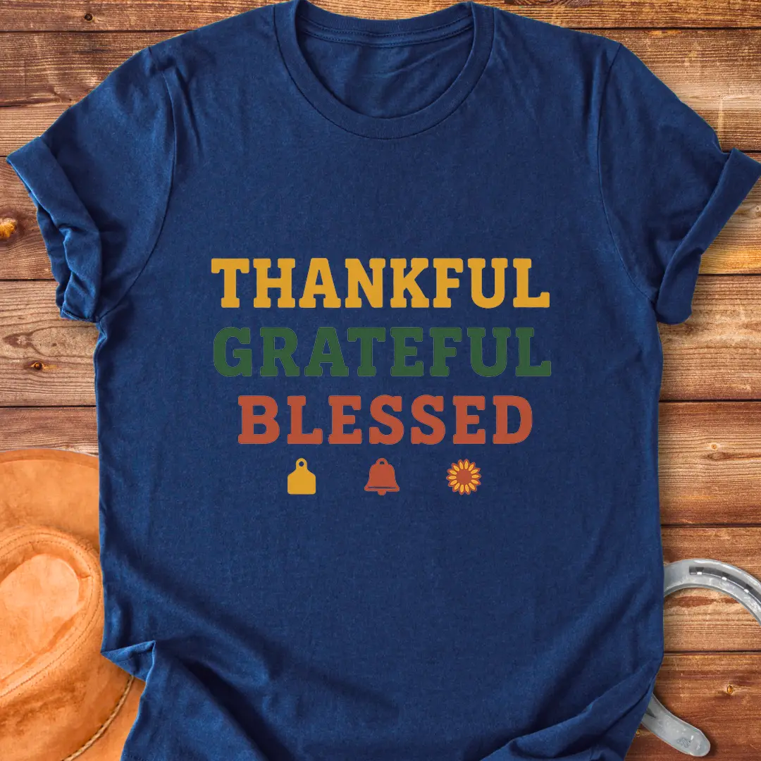 Thankful, Grateful, Blessed T-shirt with farm-themed elements like a cow tag, bell, and sunflower.