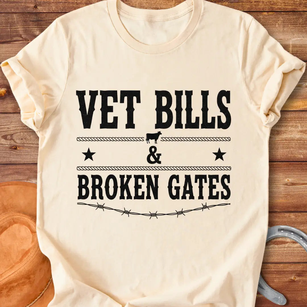 Vet Bills and Broken Gates t-shirt design with a cow silhouette, stars, and barbed wire.