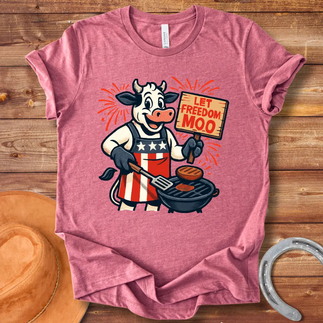 Illustration of a patriotic cow grilling burgers with a "Let Freedom Moo" sign, celebrating American Independence