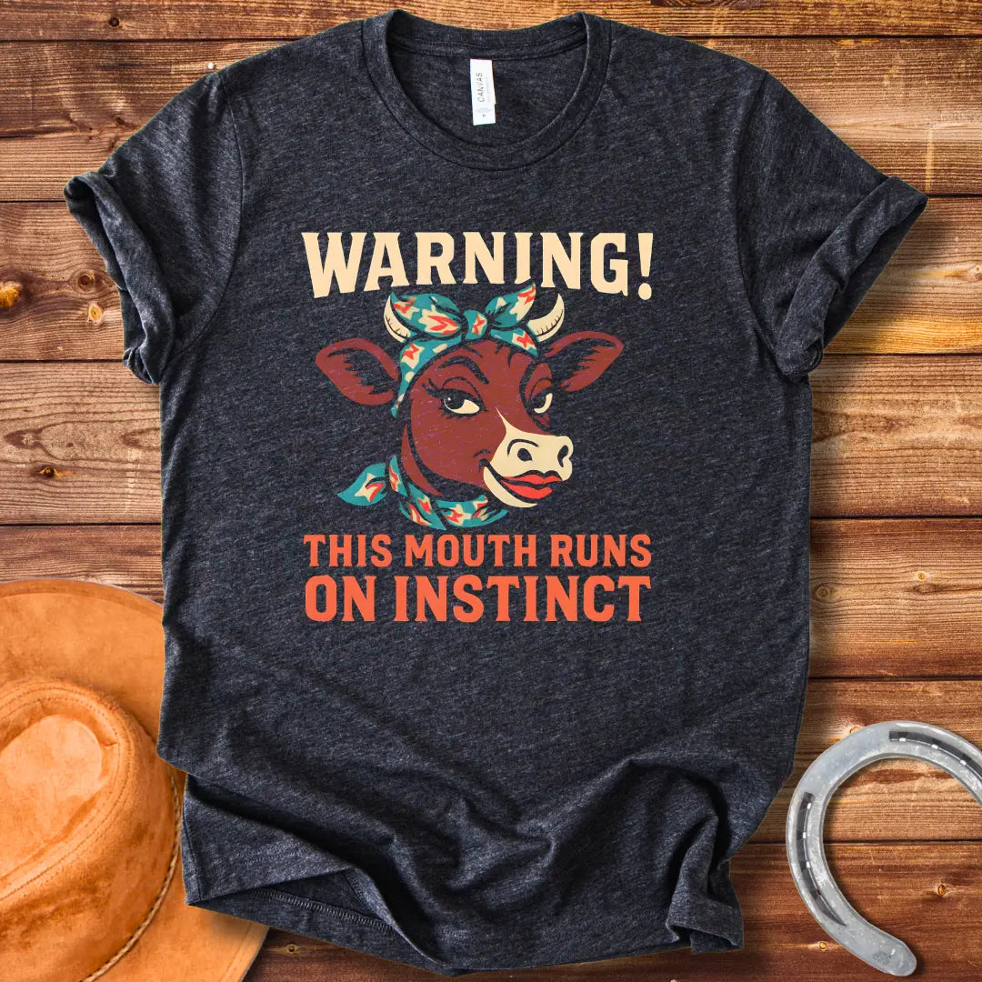 Illustration of a cow with a bandana and the words 'Warning! This Mouth Runs On Instinct' on a black background.