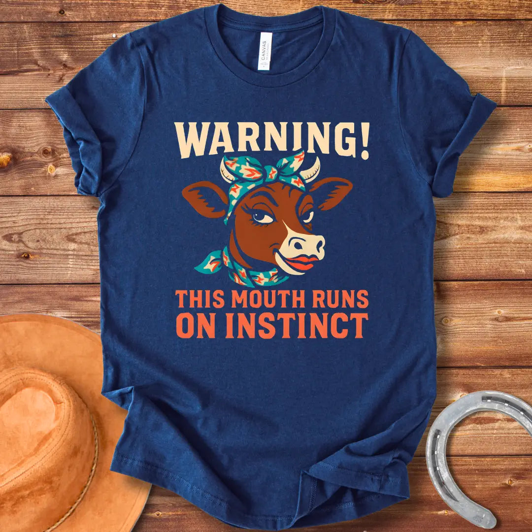 Illustration of a cow with a bandana and the words 'Warning! This Mouth Runs On Instinct' on a black background.
