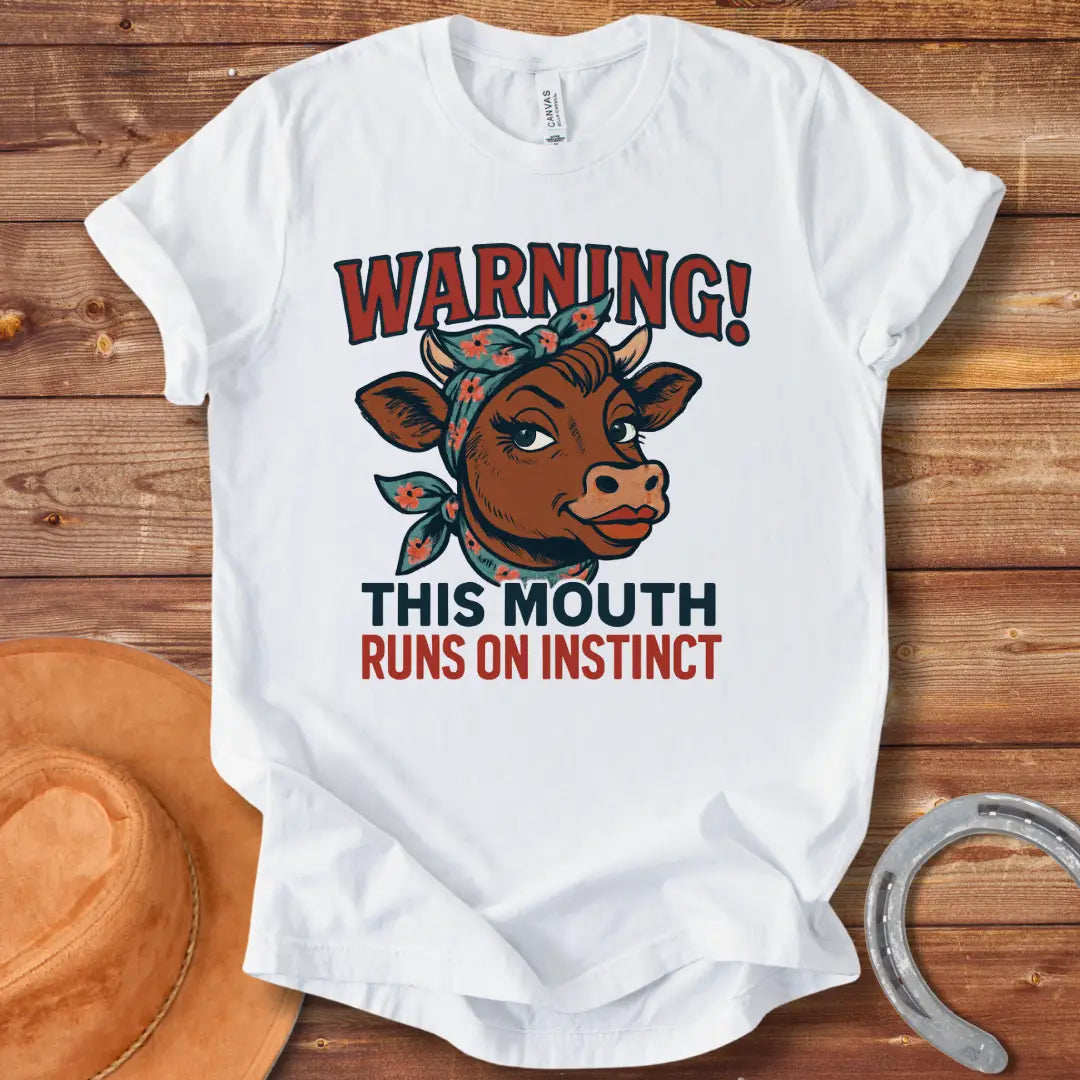 Illustration of a cow with a bandana and the words 'Warning! This Mouth Runs On Instinct' on a black background.
