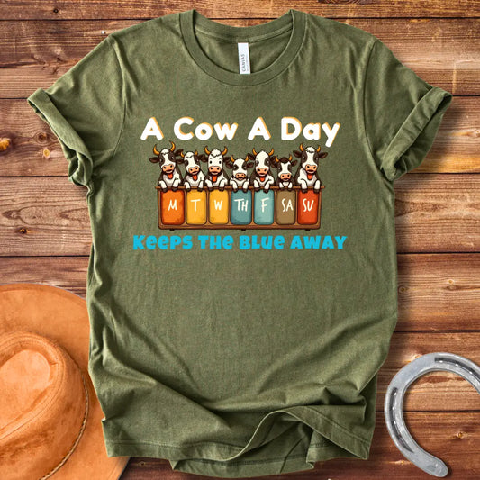 Illustration of seven happy cows each peeking over a box holding days of the week, the text at the bottom saying 'Keeps the Blue Away'.