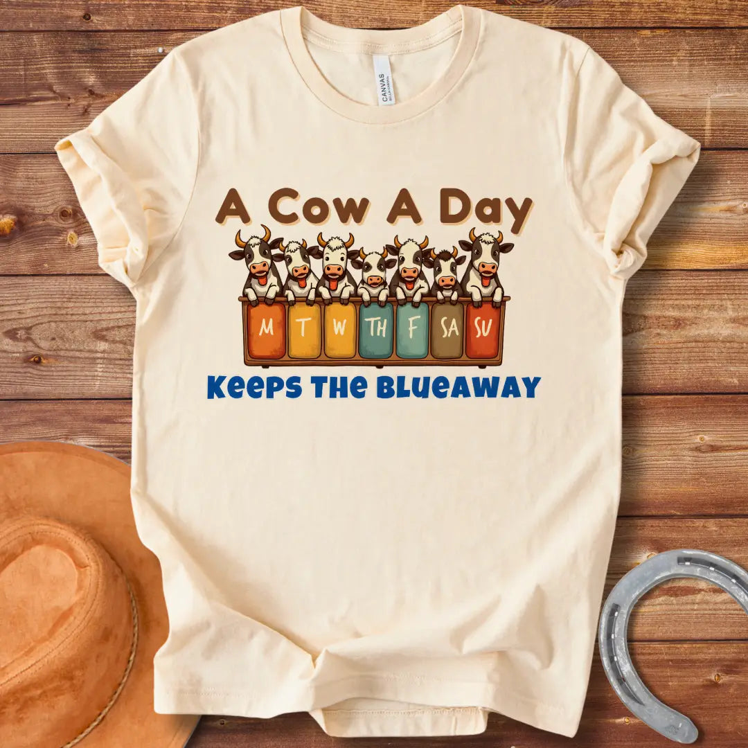 Illustration of seven happy cows each peeking over a box holding days of the week, the text at the bottom saying 'Keeps the Blue Away'.