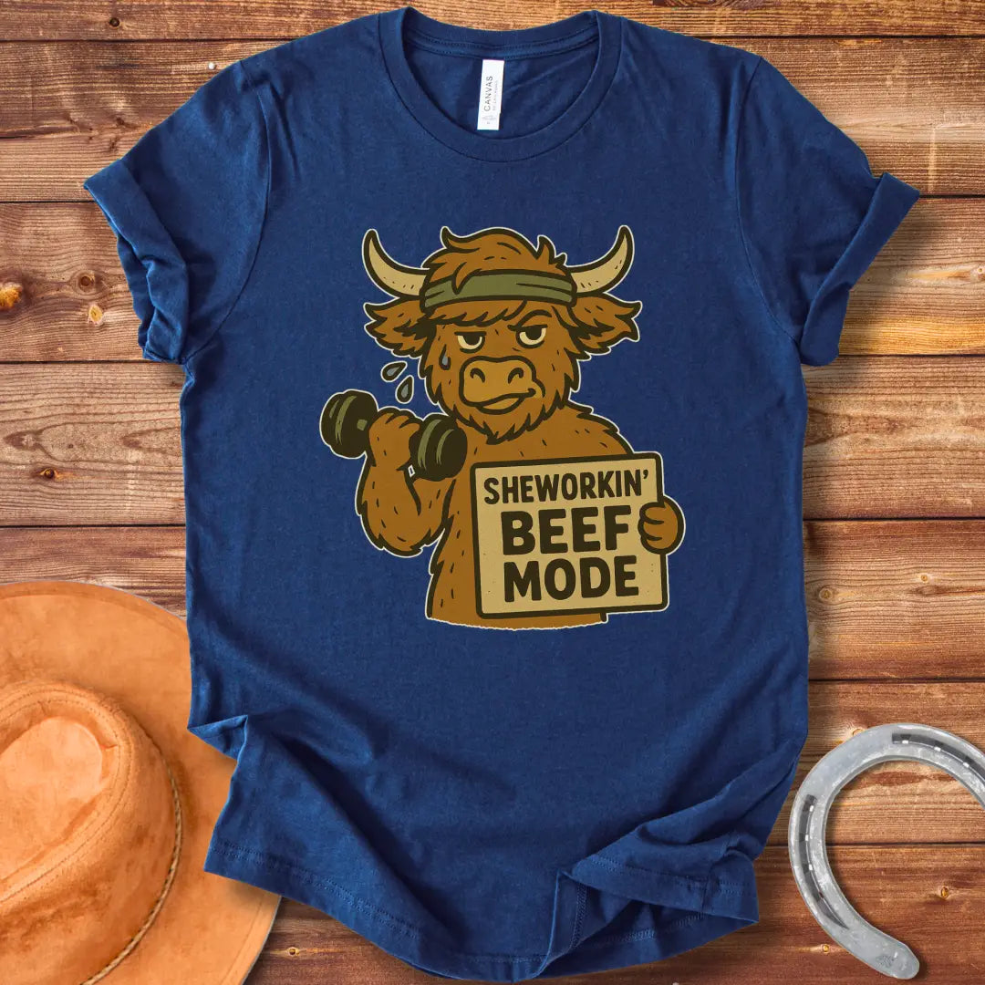 Cartoon cow working out with dumbbells, wearing a headband and holding a sign that says 'Sheworkin' Beef Mode'