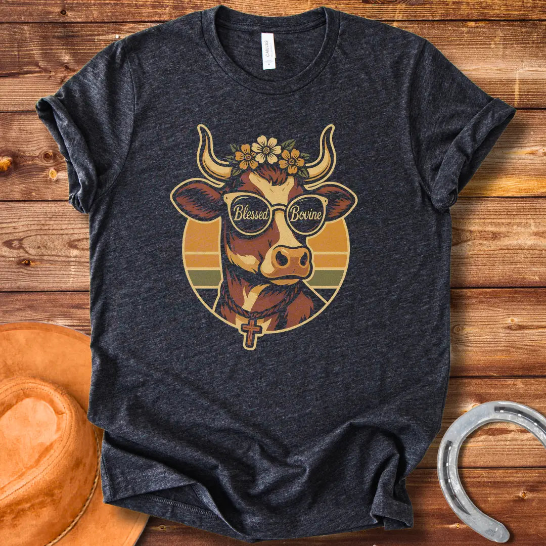 Blessed Bovine T-shirt design featuring a cow wearing sunglasses that say blessed bovine with a floral crown and a rosary.