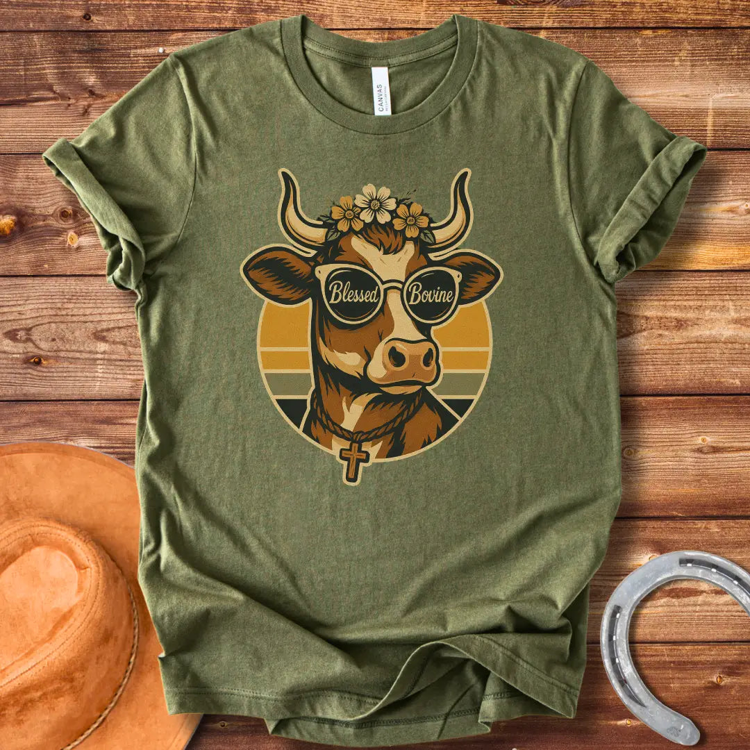 Blessed Bovine T-shirt design featuring a cow wearing sunglasses that say blessed bovine with a floral crown and a rosary.