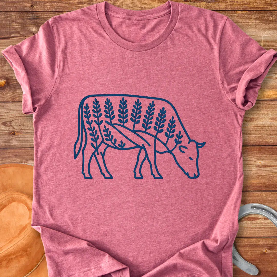 Bluebonnet cow illustration t-shirt design, showing a cow with floral elements within its silhouette.