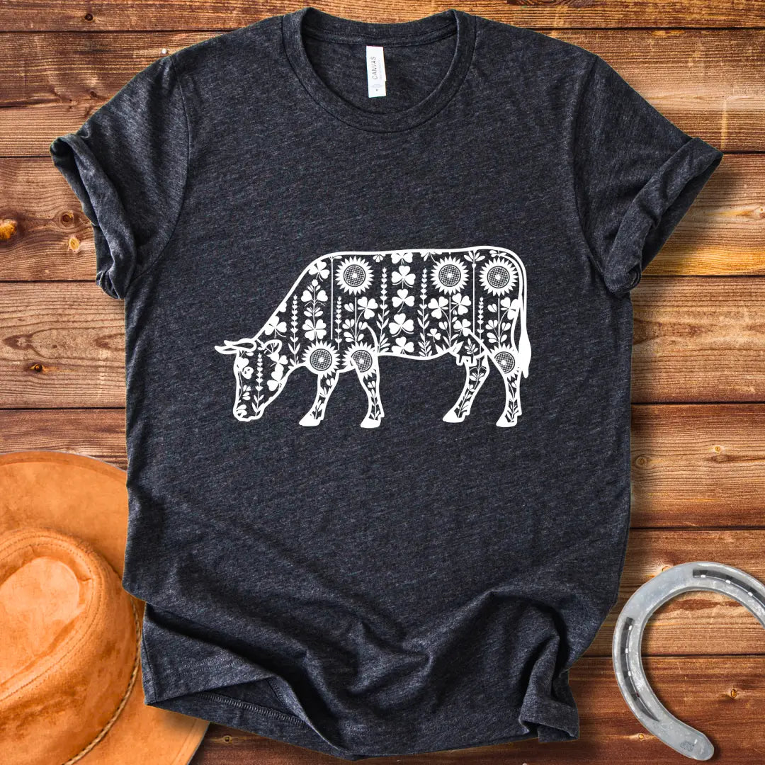Detailed line art of a cow grazing, filled with floral patterns including sunflowers and shamrocks, perfect for cow lovers.