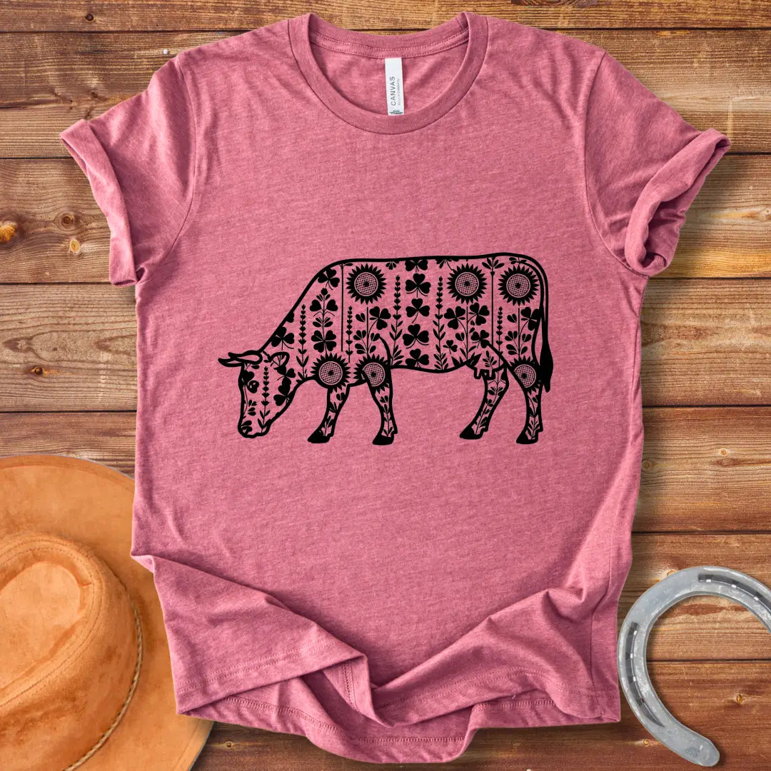 Detailed line art of a cow grazing, filled with floral patterns including sunflowers and shamrocks, perfect for cow lovers.