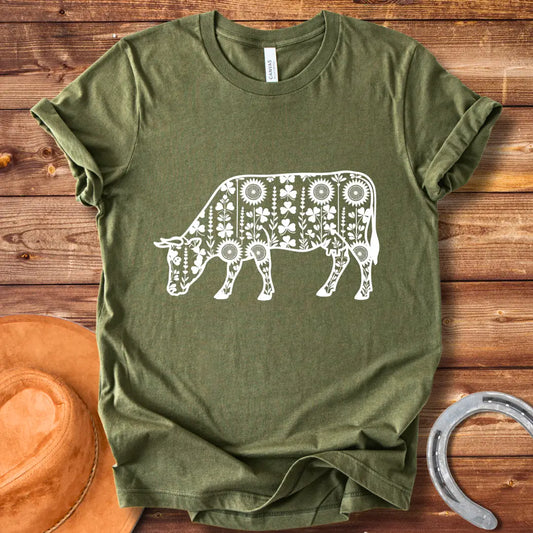 Detailed line art of a cow grazing, filled with floral patterns including sunflowers and shamrocks, perfect for cow lovers.