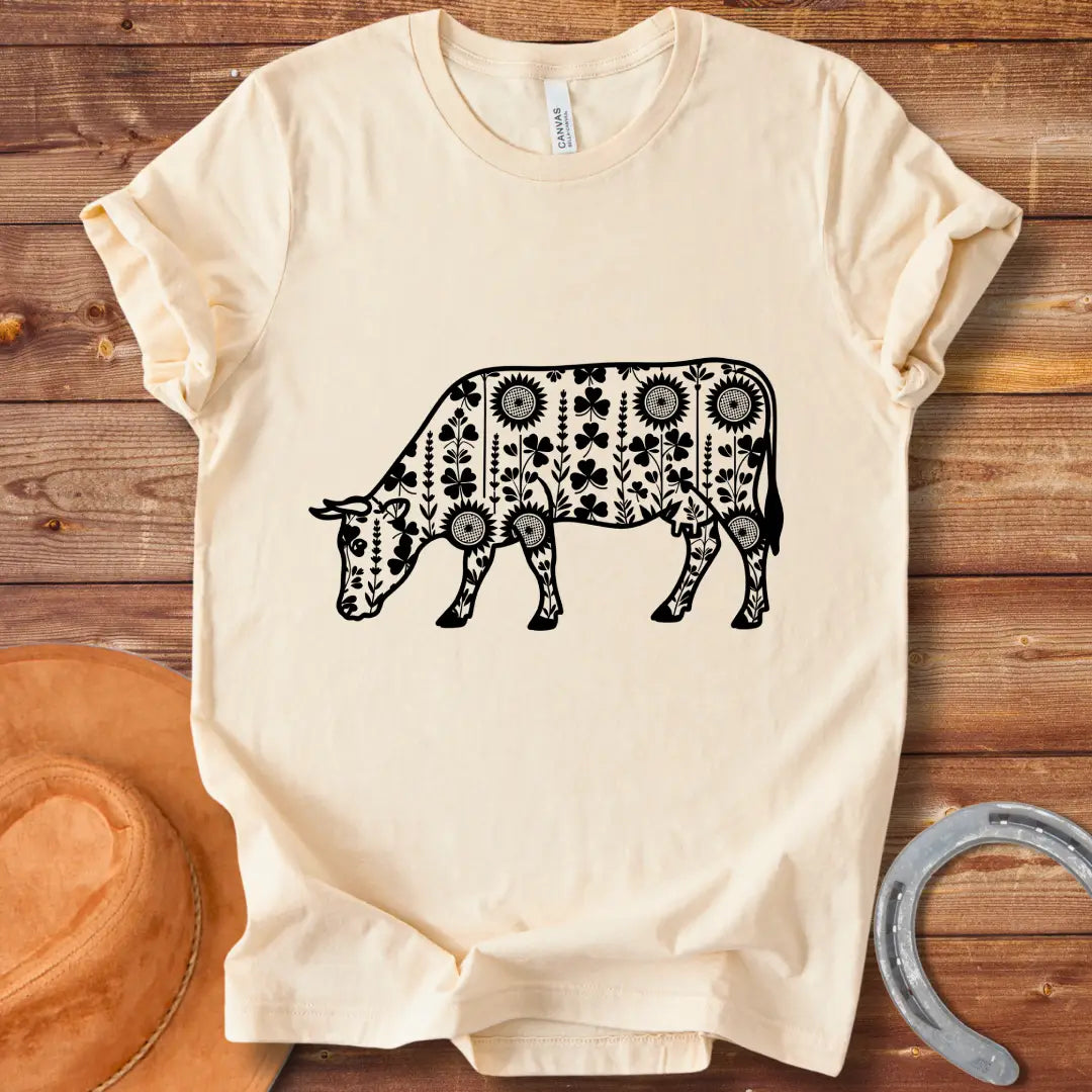 Detailed line art of a cow grazing, filled with floral patterns including sunflowers and shamrocks, perfect for cow lovers.