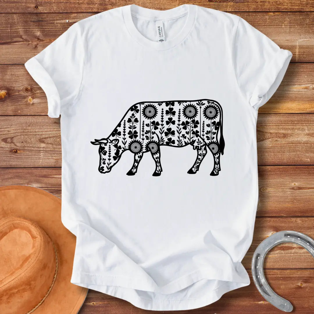 Detailed line art of a cow grazing, filled with floral patterns including sunflowers and shamrocks, perfect for cow lovers.
