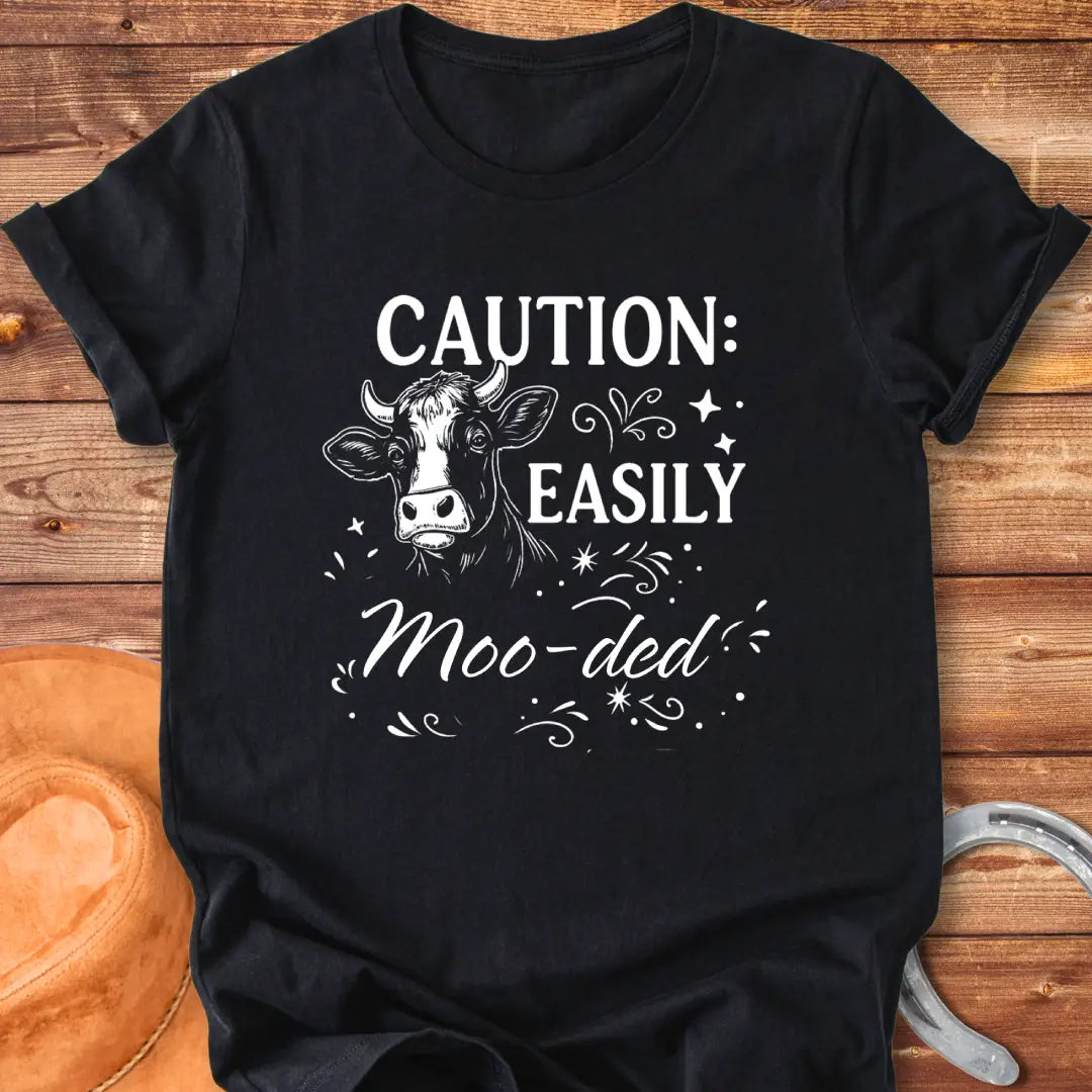 Caution: Moo-ded T-shirt featuring a detailed cow illustration with decorative elements.