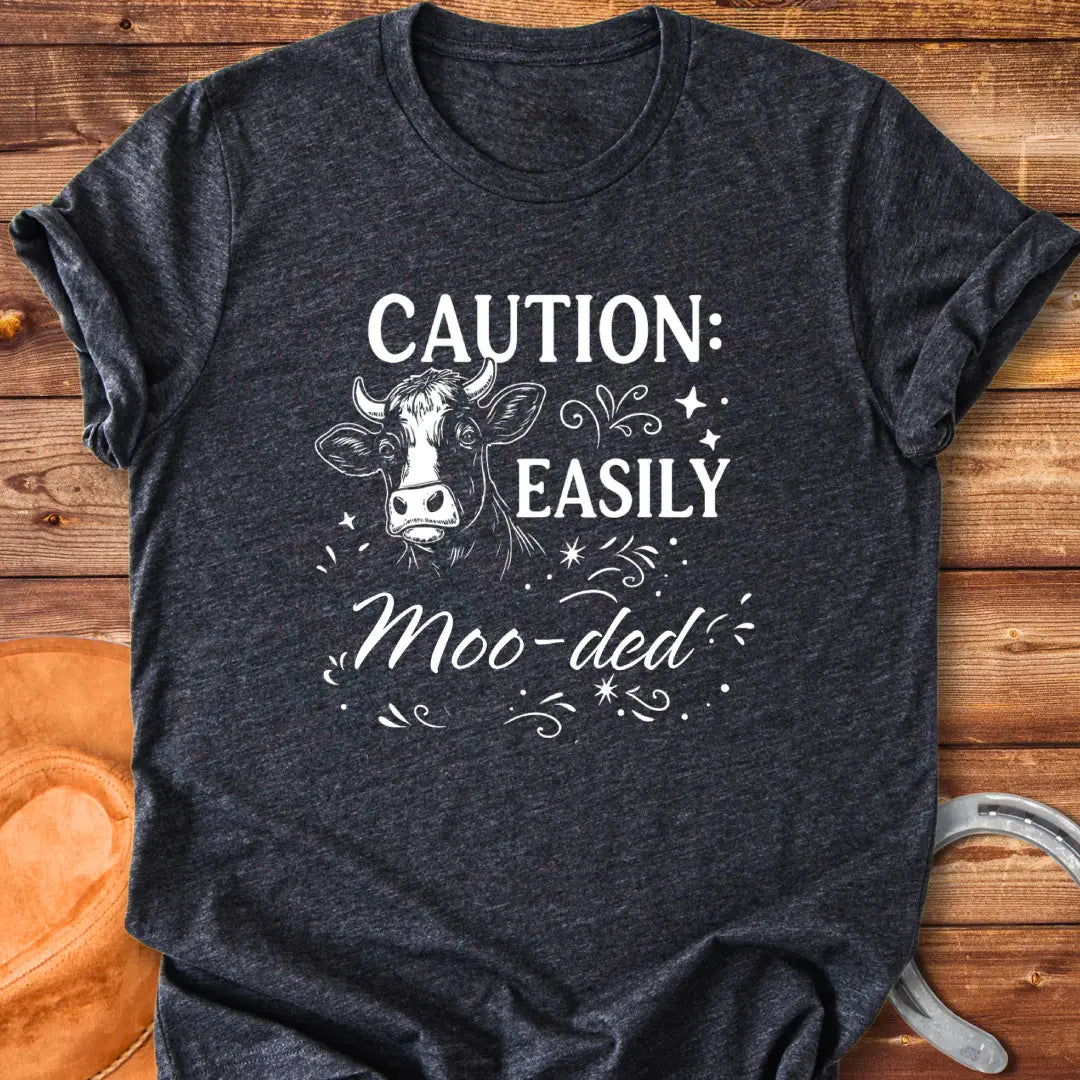 Caution: Moo-ded T-shirt featuring a detailed cow illustration with decorative elements.