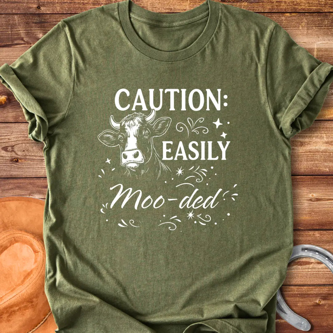 Caution: Moo-ded T-shirt featuring a detailed cow illustration with decorative elements.