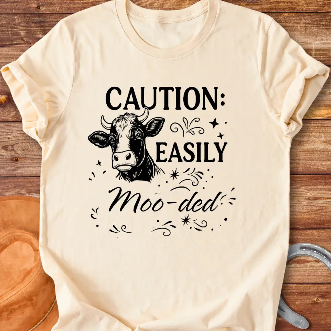 Caution: Moo-ded T-shirt featuring a detailed cow illustration with decorative elements.