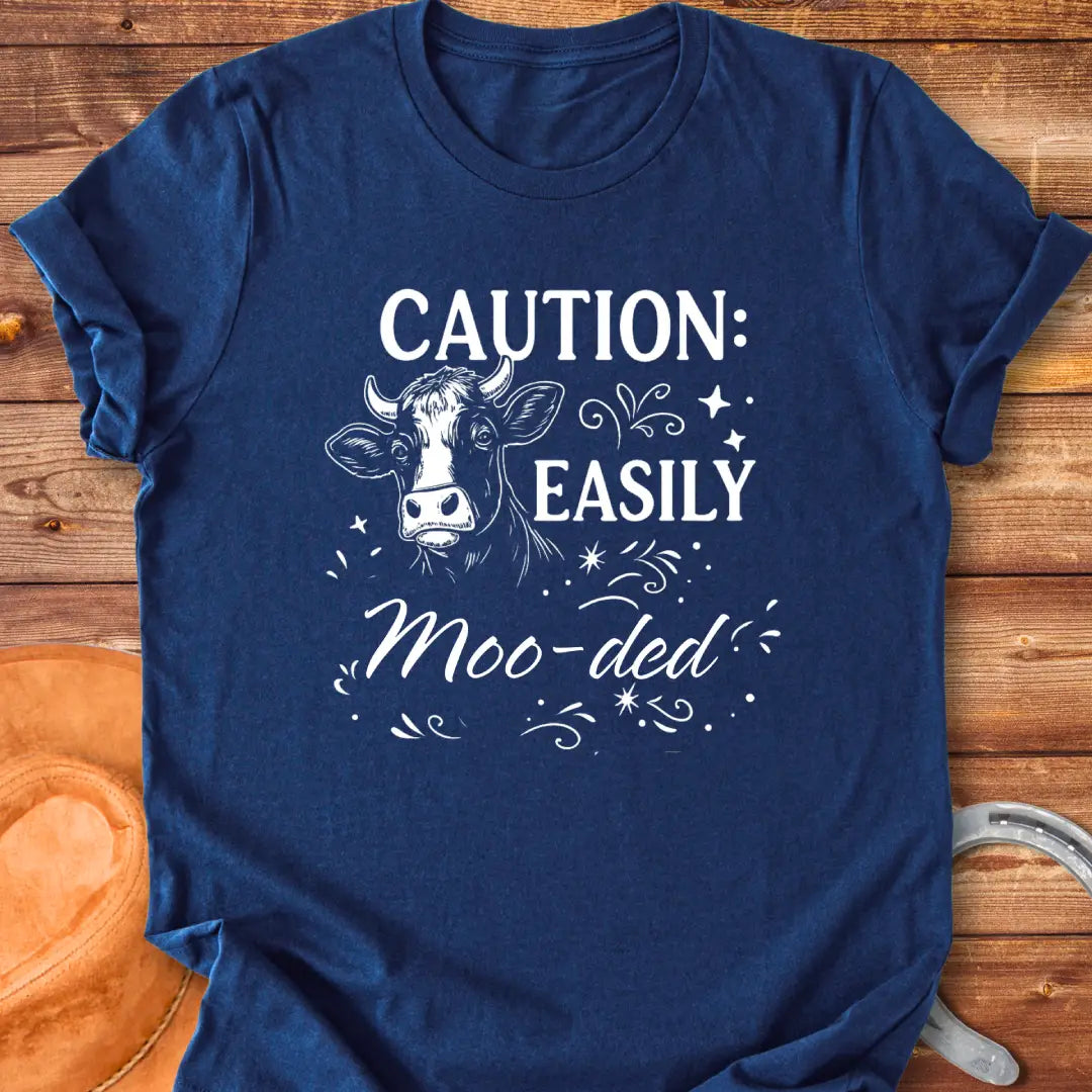 Caution: Moo-ded T-shirt featuring a detailed cow illustration with decorative elements.