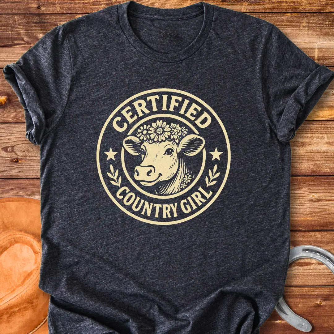 Certified Country Girl T-shirt featuring a cow with a floral crown inside a circular design.