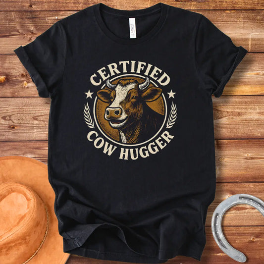 Certified Cow Hugger T-Shirt featuring a smiling cow illustration inside a circular emblem.