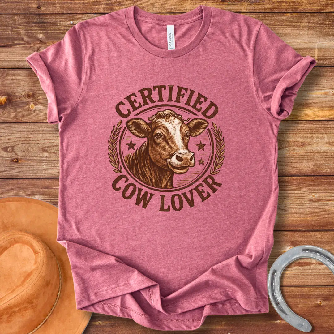 Certified Cow Lover T-shirt featuring a detailed illustration of a cow's face within a circular emblem with the text 'Certified Cow Lover'.