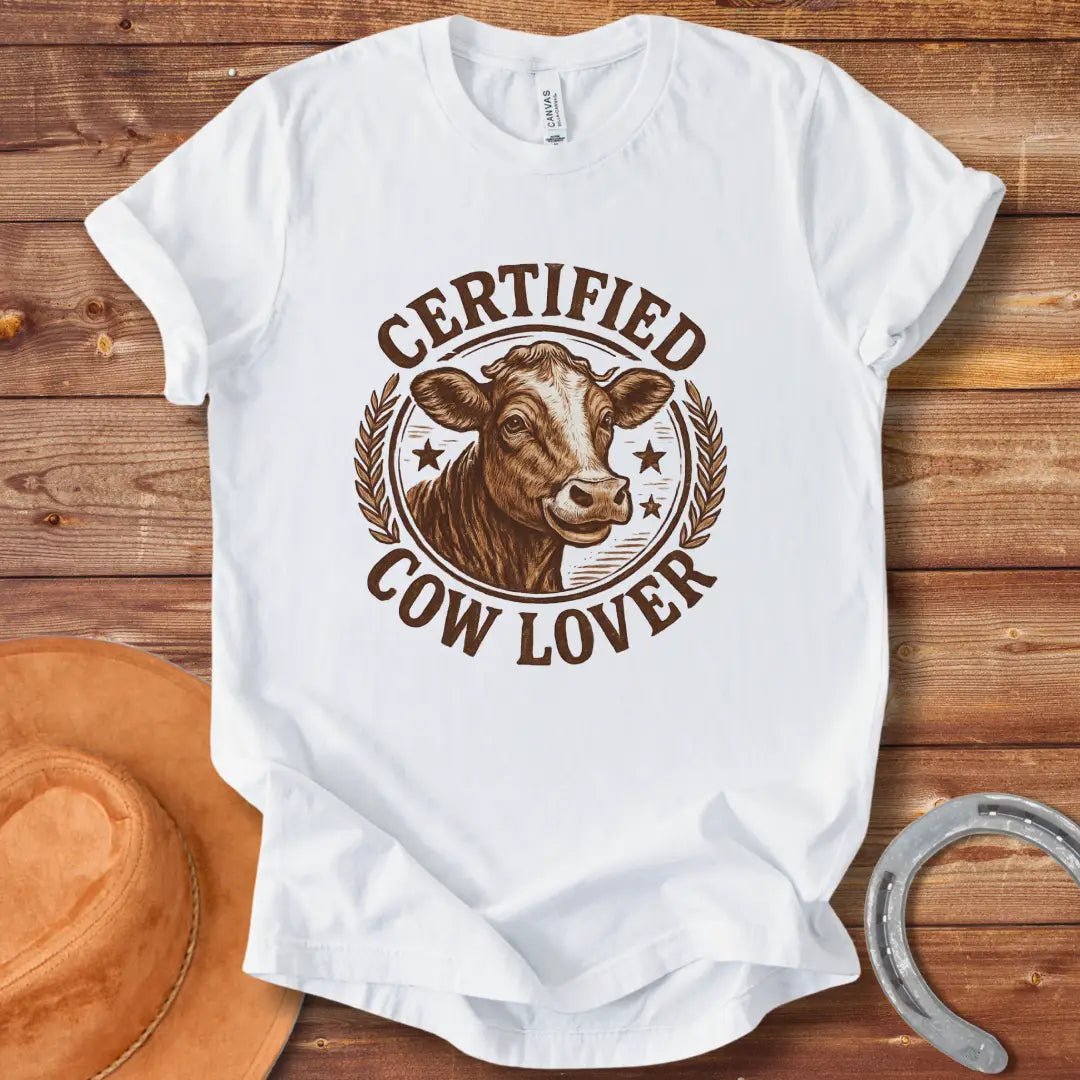 Certified Cow Lover T-shirt featuring a detailed illustration of a cow's face within a circular emblem with the text 'Certified Cow Lover'.