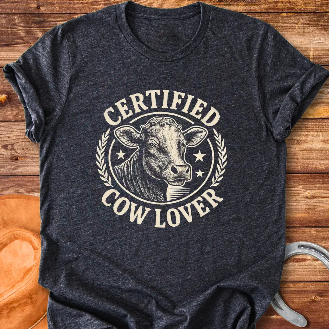 Vintage dark t-shirt with a detailed illustration of a cow and text that says 'Certified Cow Lover'.