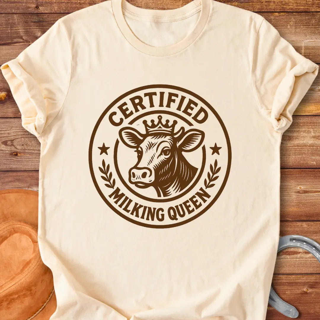 Certified Milking Queen T-Shirt design with a cow wearing a crown, and the words 'Certified Milking Queen' in a circular emblem.