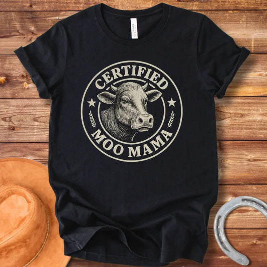 Certified Moo Mama T-shirt design with a detailed illustration of a cow's head inside a seal with the words 'Certified Moo Mama' around the edge.