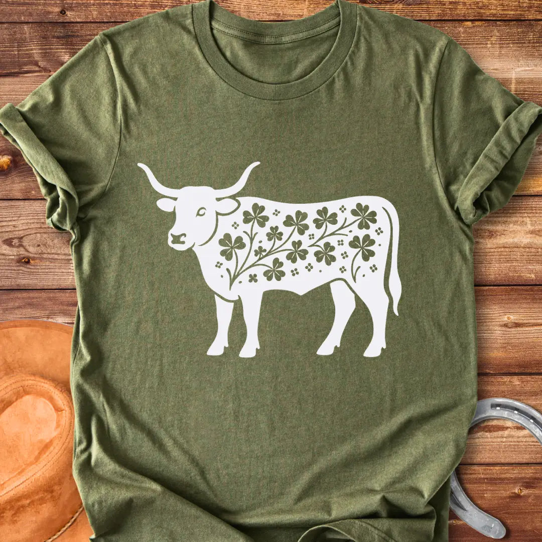 Black silhouette of a longhorn cow with clover patterns on its body