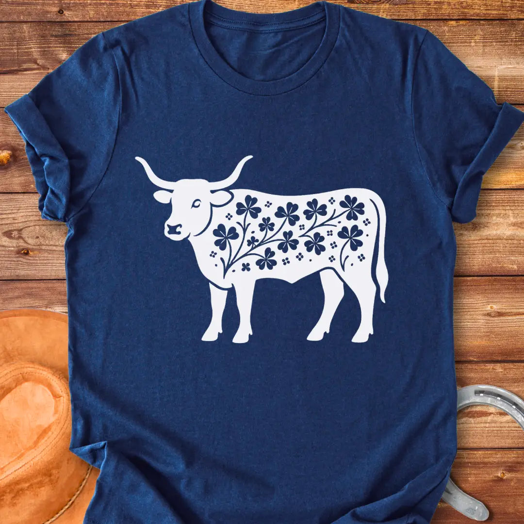 Black silhouette of a longhorn cow with clover patterns on its body