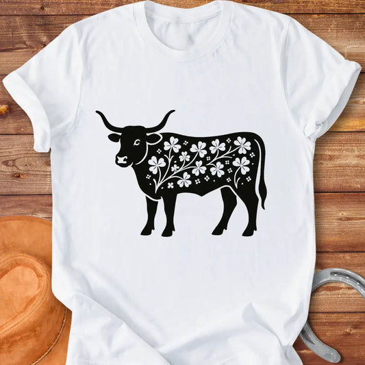 Black silhouette of a longhorn cow with clover patterns on its body