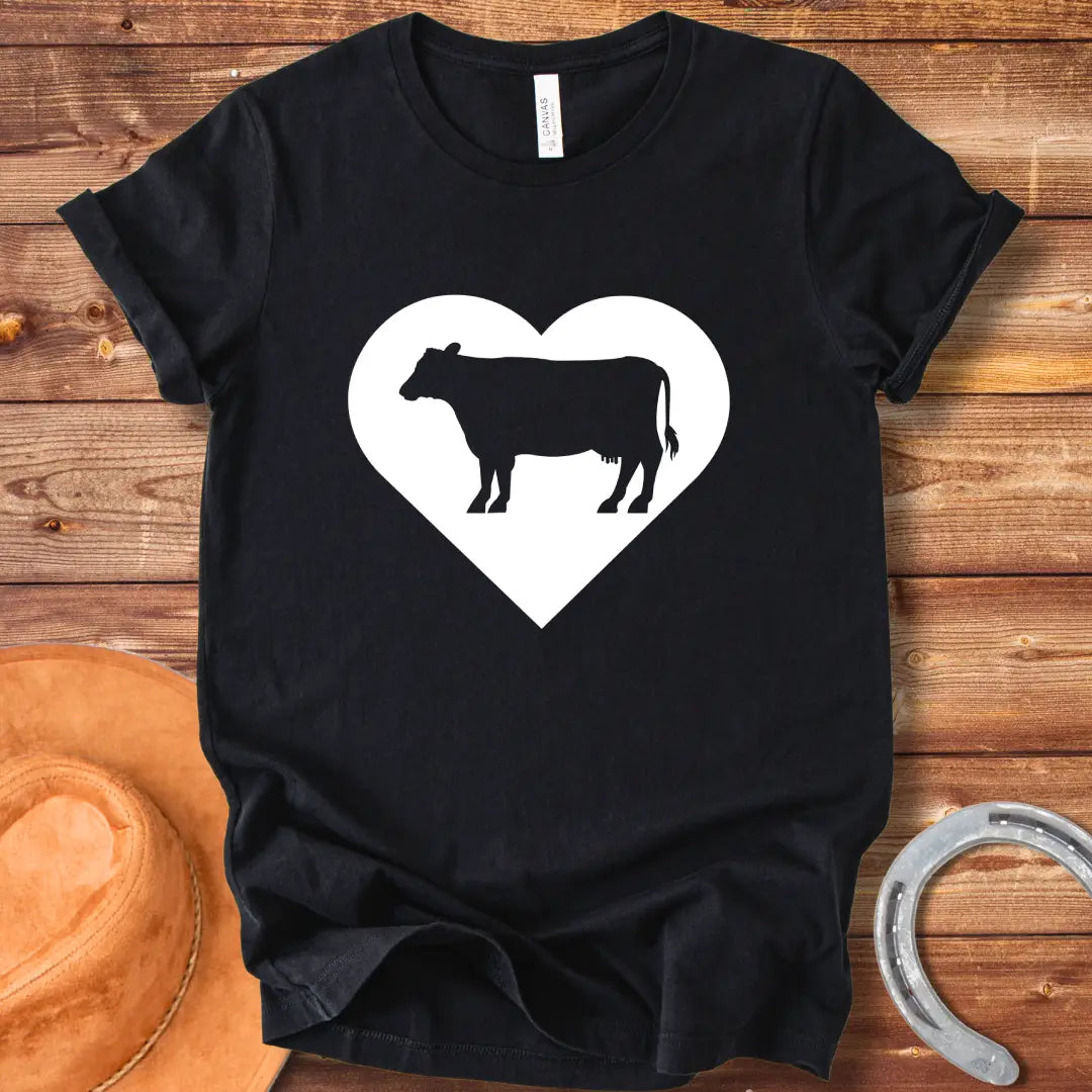 Black silhouette of a cow inside a grey heart on a black background. Perfect for cow lovers.