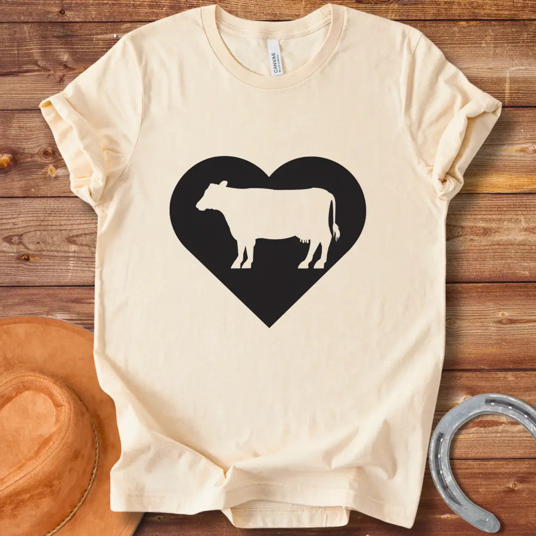 Black silhouette of a cow inside a grey heart on a black background. Perfect for cow lovers.